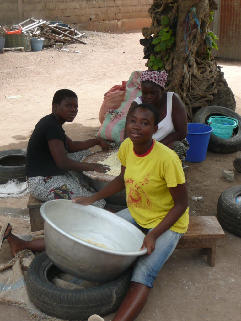 Women as  usual not being lazy, here making attieke (a cassava based food similar to cous cous) in Cote d'Ivoire