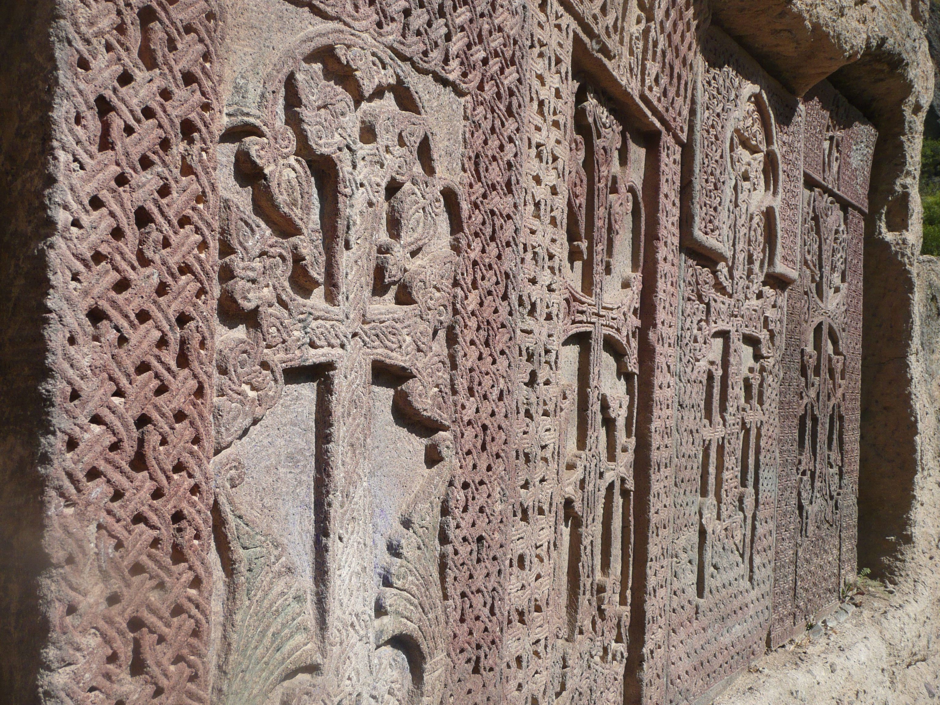Khatchkars - gravestones stained with beetle dye, still coloured after 800 years of weather. NB: image of the cross is growing out of the pre-christian tree of life symbol