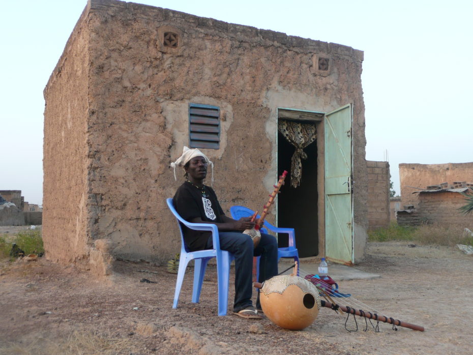 Mamadou outside his home