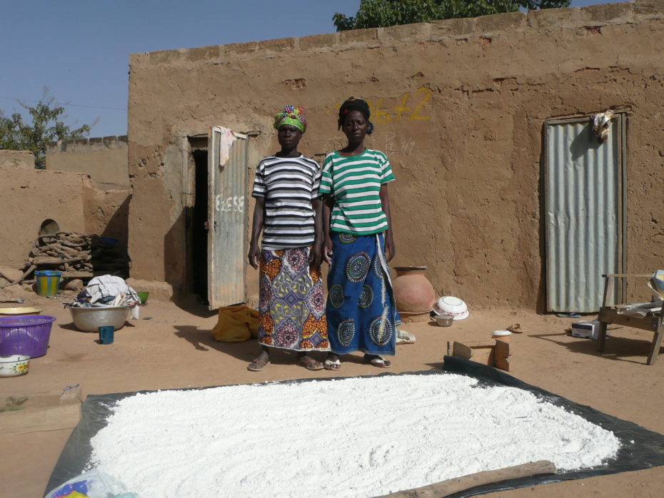 The wives (it's a Muslim family) in charge of drying out the maize flour. Toilet/shower combo on left of home