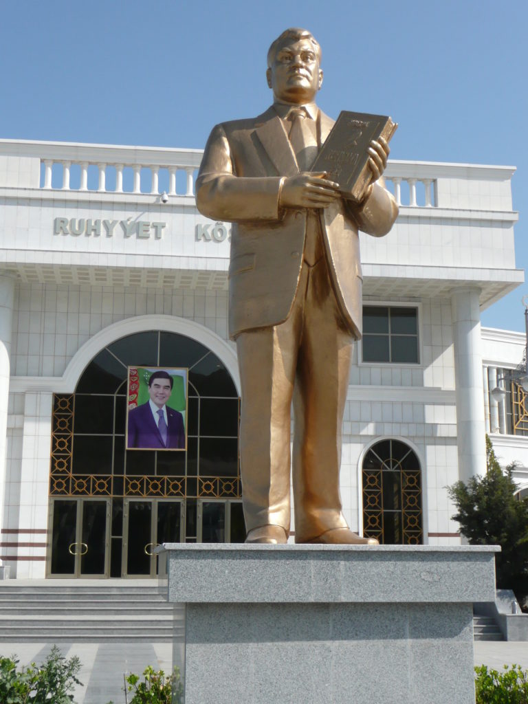 Statue of former President Niyazov and poster of his successor Gurbanguly Berdimuhamedow