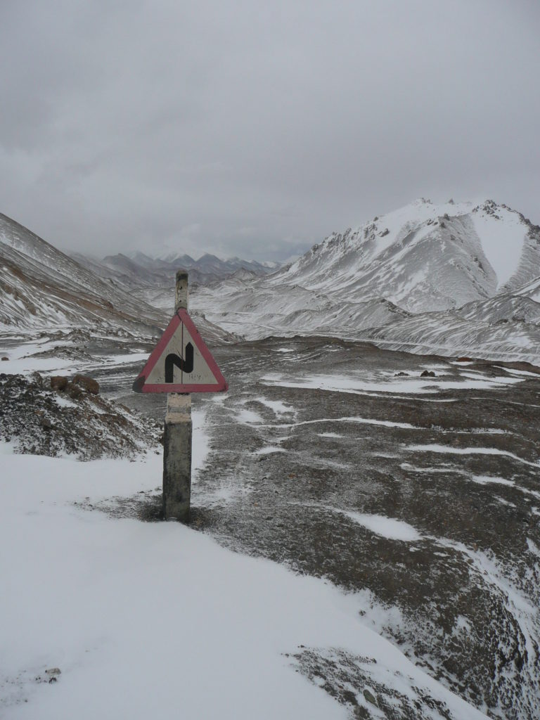 The most superfluous road sign in Tajikistan, who would believe there would be bends in the road when driving over a 4600m mountain pass