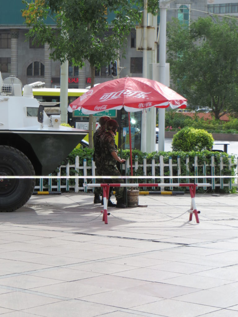 Soldiers hard at work under a parasol