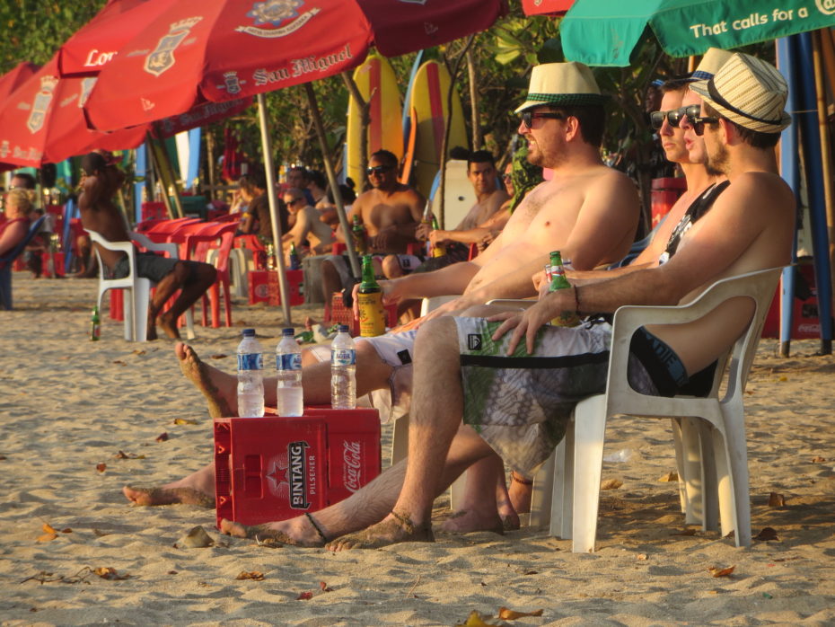 Typical beach users enjoying the finer points of Balinese culture