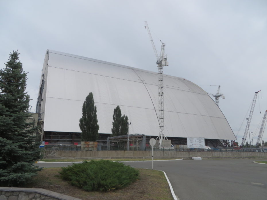 This new steel hangar is on tracks and will be rolled over the plant to seal it while aoutomated machinery works inside to make the core permanently safe