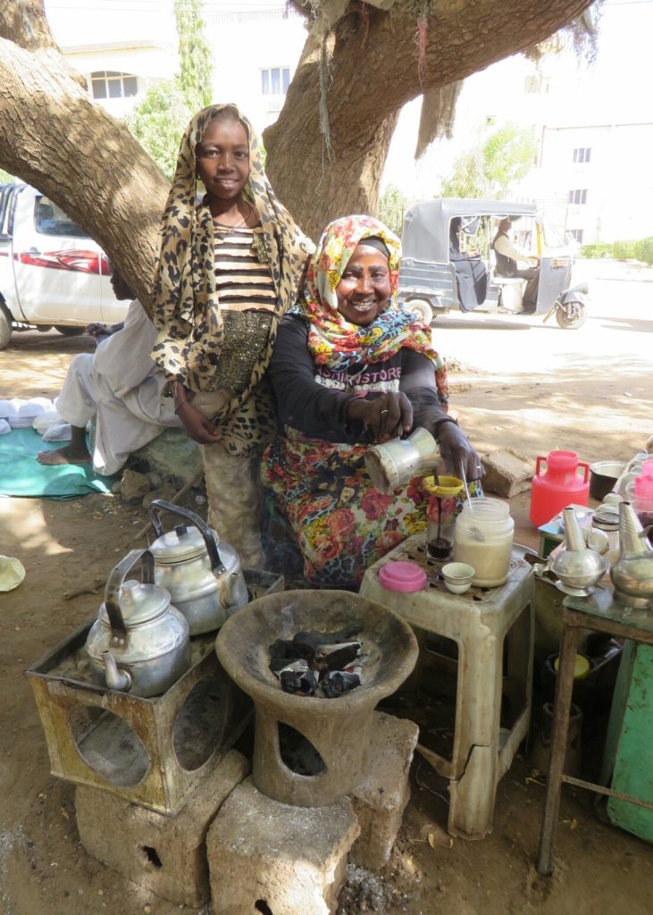 Zeinab and her daughter Alaya providing tea with a smile in Wad madani